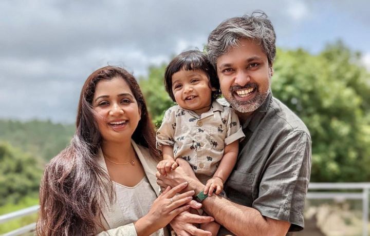 shreya ghoshal and her husband holding their baby Devyaan