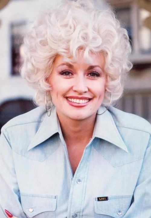 dolly parton curly hairs and denim jacket